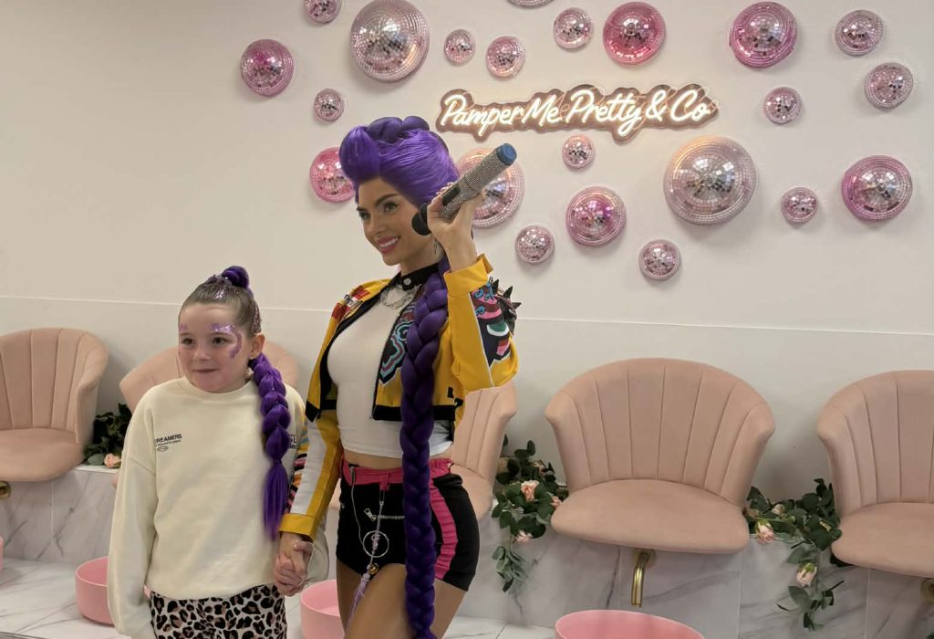 Child meeting a costumed entertainer at a Pamper Me Pretty party