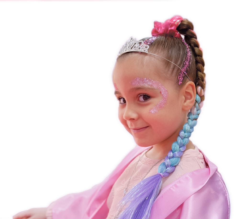 Smiling girl wearing a tiara and face gems at a Pamper Me Pretty party