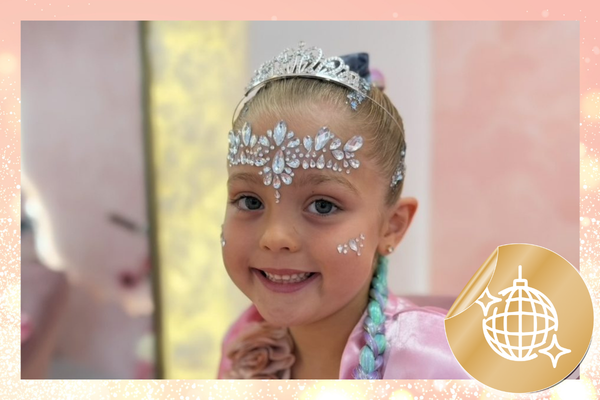 Girl with a tiara and gem face decoration at a Gold package party